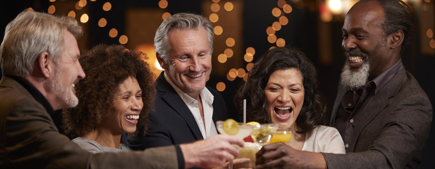 a group of people sitting at a table with drinks