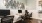 a room with a desk and chairs