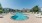 a swimming pool with lounge chairs around it