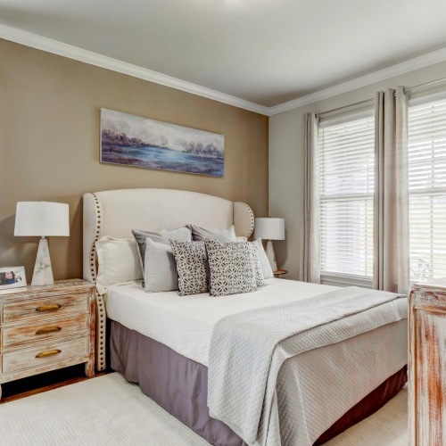 a bedroom with a bed and lamps