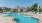 a swimming pool with chairs around it