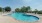 a swimming pool with chairs around it